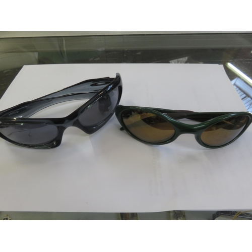 120 - Two Pairs of Oakley  Sunglasses in Covers