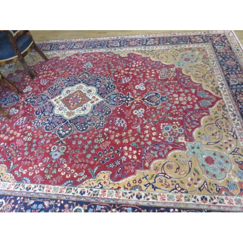 434A - Fringed Rug on red and blue ground, centre medallion 347 x 250 cm.