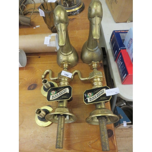 186 - Two Black Bottle Whisky Tops and Two Brass Bookends