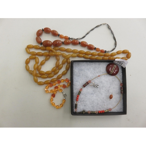 102 - Quantity of Amber Type Jewellery