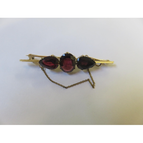 21 - Three Stone Garnet, 9ct Gold Bar Brooch