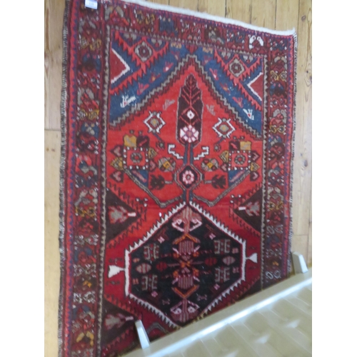 377 - Fringed Persian Rug - Central Medallion Design on Red Ground, 187 x 94 cms.