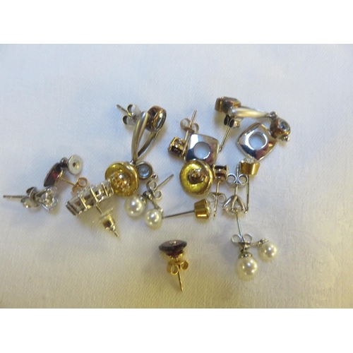 74 - Three Pairs of 9c Gold Earrings and Several Pairs of Silver Earrings