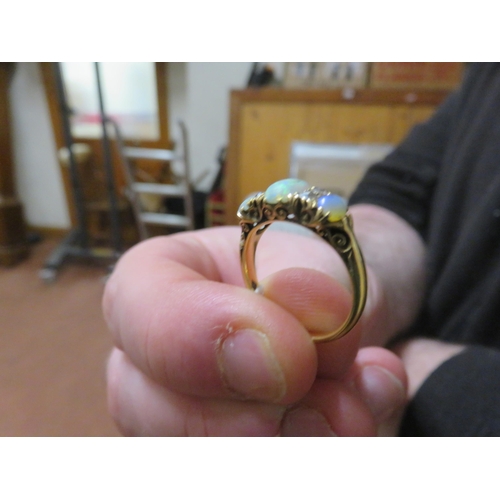 72 - Yellow Metal Ring with three opal stones and four white stones