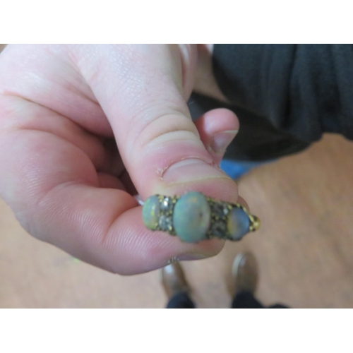 72 - Yellow Metal Ring with three opal stones and four white stones