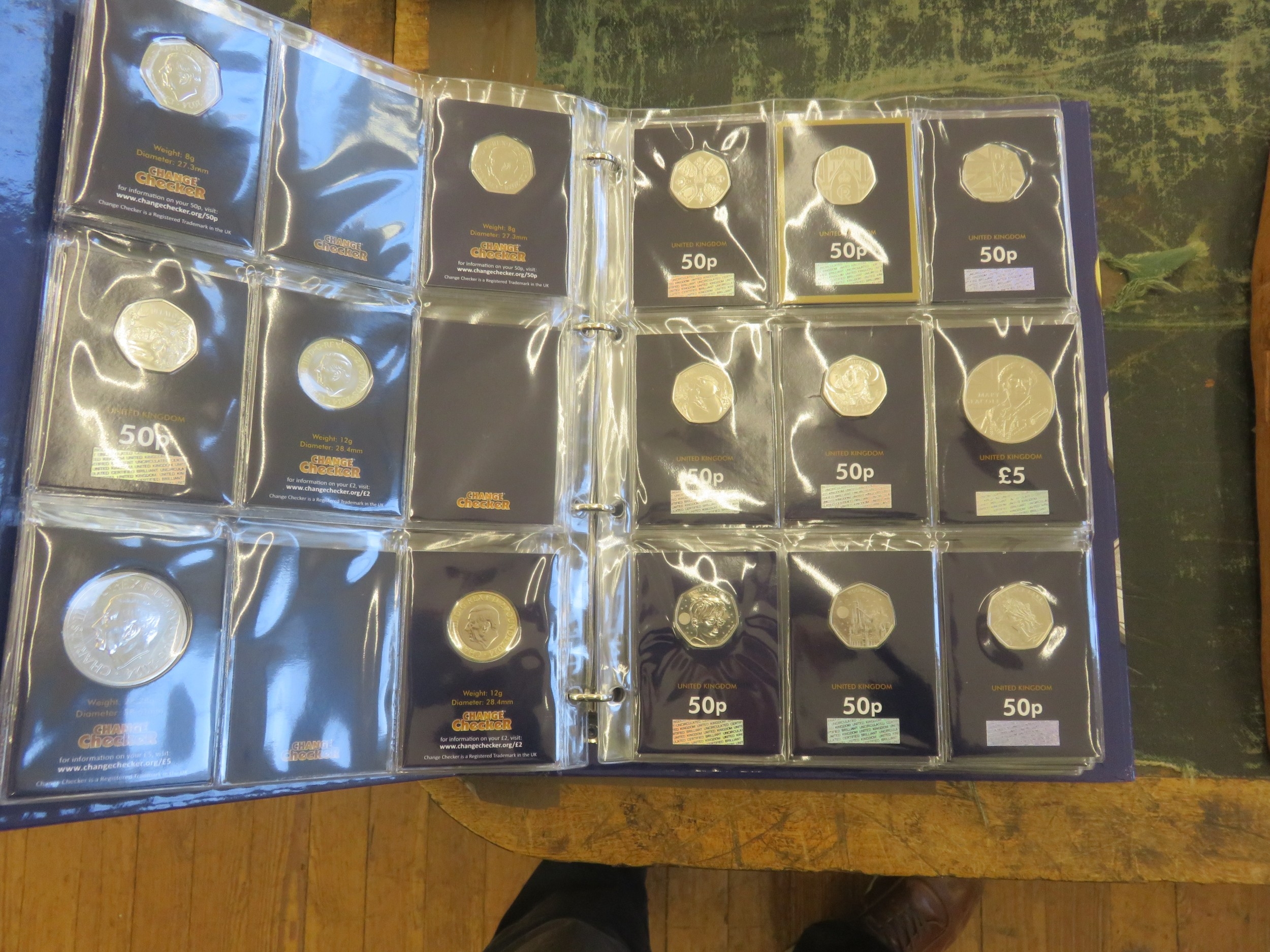 Change Checker Album containing Commemorative Coin Sets and 50 pence Coins