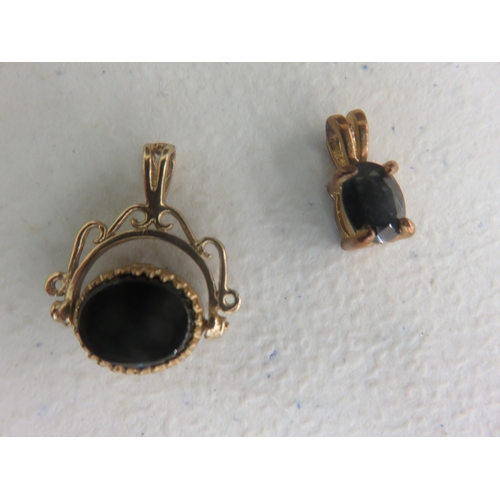 79 - Small 9ct. Gold Mounted Swivel Pendant and one other