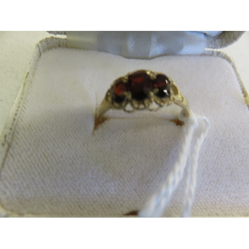 93 - 9ct. Gold three Stone Garnet Dress Ring