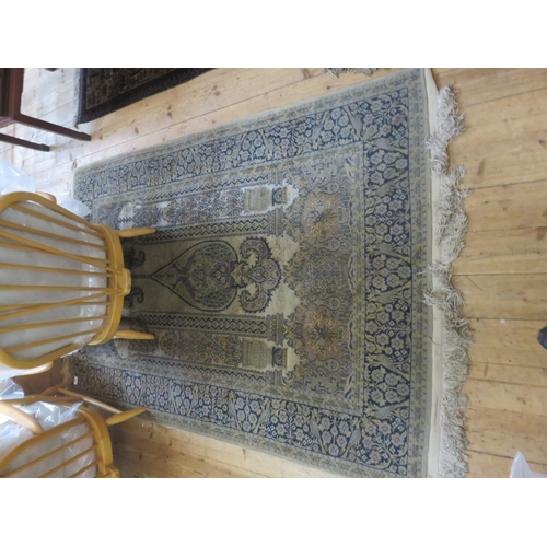 389 - Cream and blue fringed rug, 75 by 40 inches