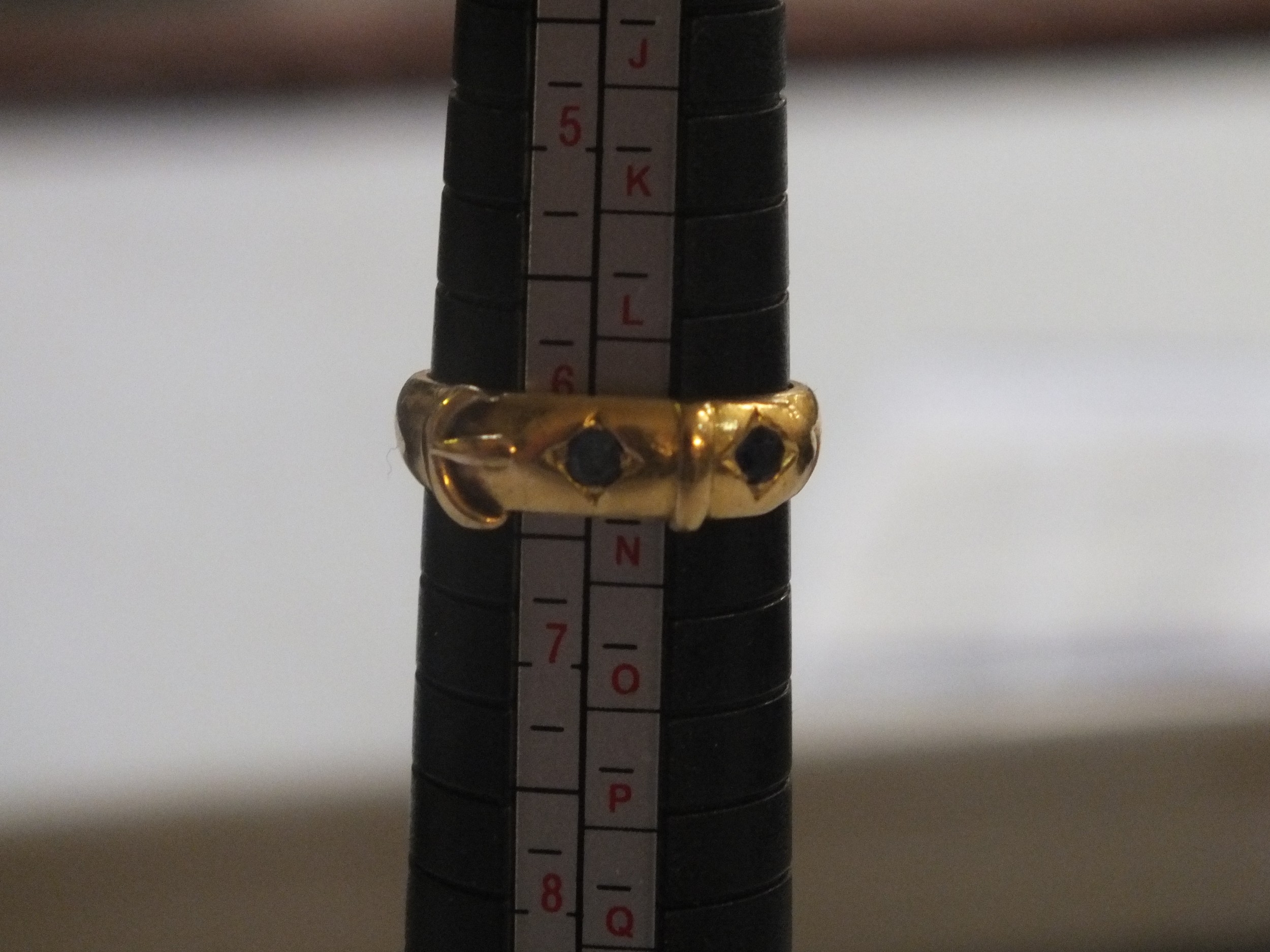 Yellow Metal and Sapphire Buckle Rings, 5.5g