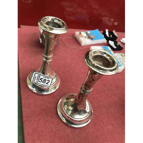 582 - Pair of silver candlesticks