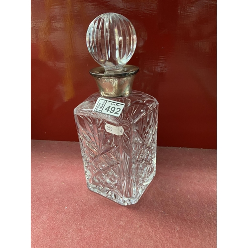 492 - Cut glass decanter with silver collar