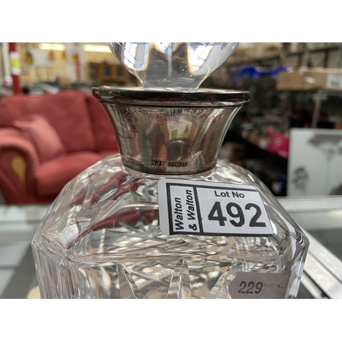 492 - Cut glass decanter with silver collar