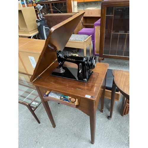 311 - Jones sewing machine in cabinet