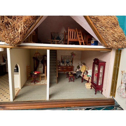 503 - Thatch roof doll's house and contents