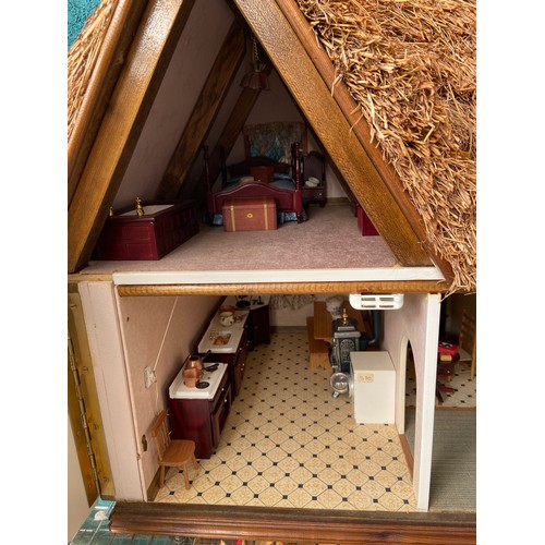 503 - Thatch roof doll's house and contents