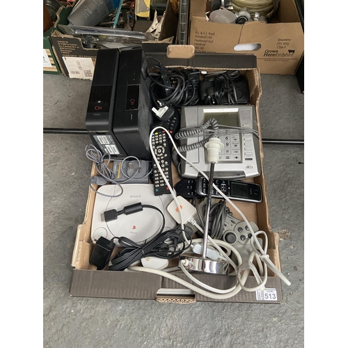 513 - Box containing a PlayStation One, cables and a phone etc