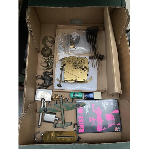 67 - Box containing brass camels, a clock movement and a model aeroplane etc