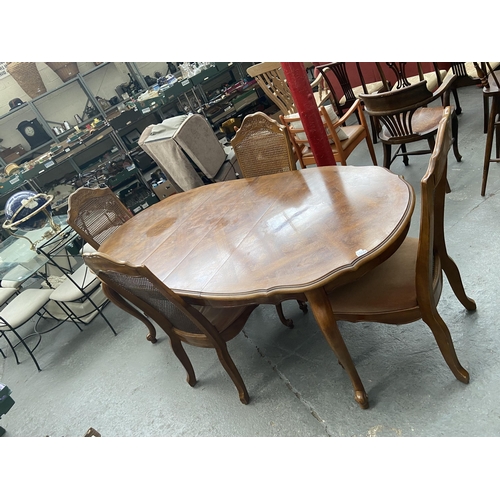 544 - Extending italianate dining table and 4 rattan backed chairs