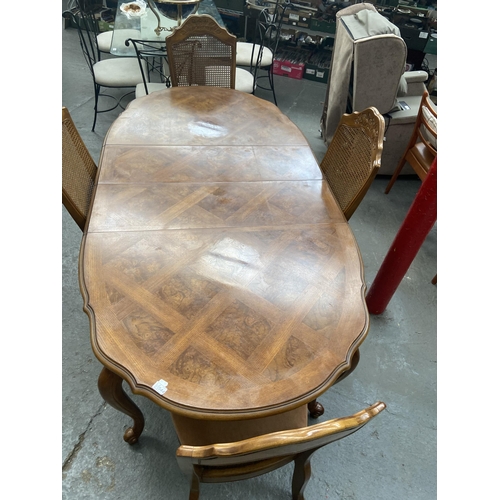 544 - Extending italianate dining table and 4 rattan backed chairs