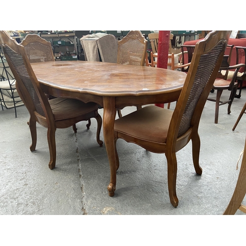 544 - Extending italianate dining table and 4 rattan backed chairs