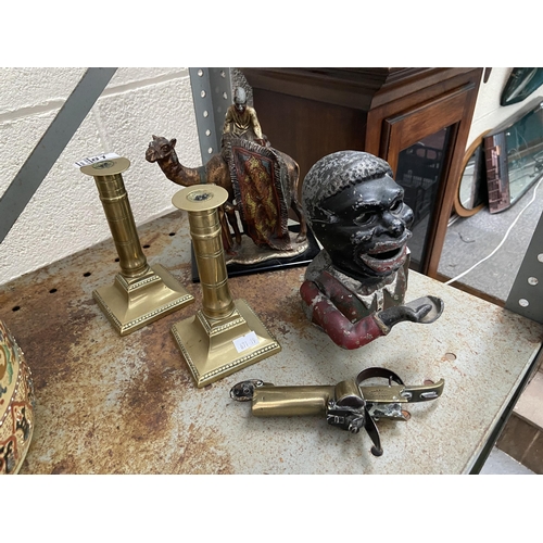 81 - Jolly man money box, and a pair of brass candlesticks etc