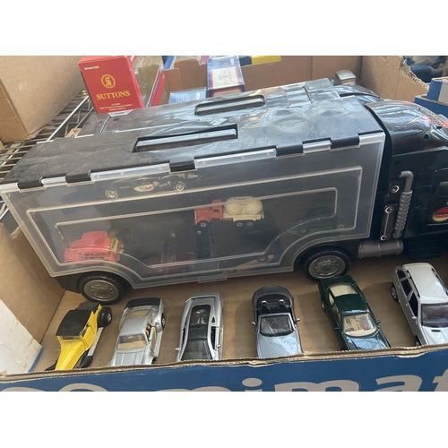 574 - Box containing die cast vehicles and 2 truck carry cases