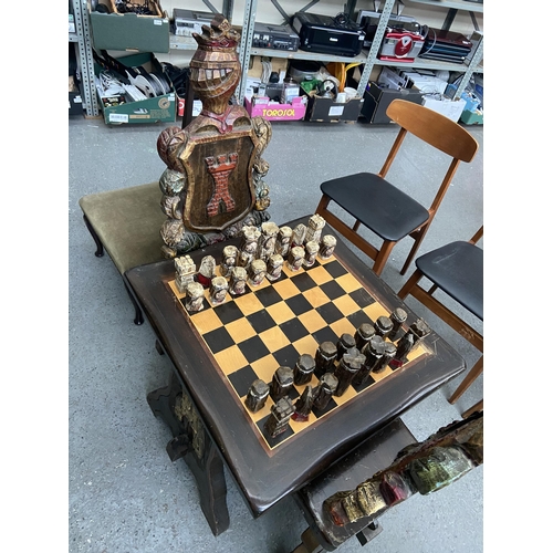 650 - Ornately carved chess table and 'Knight' chairs