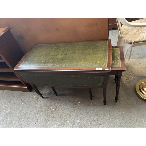 327 - Leather top drop leaf table with pull-out side tables