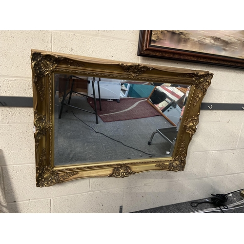 591 - Ornately framed bevel edged mirror