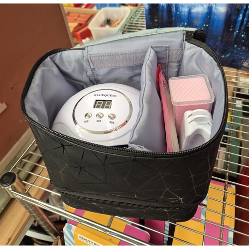 217 - Cosmetic bag containing a nail kit including UV lamp and powdered nail kit
