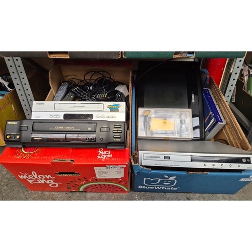 197 - 2 Boxes containing electronics including assorted remotes and cables, Philips and Toshiba VCRs etc