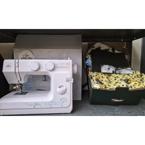 217 - So Crafty electric sewing machine and a box of assorted material (foot pedal/ mains lead included)