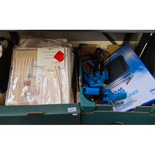 221 - 2 Boxes containing a quantity of new curtains and a Solar power battery maintainer etc