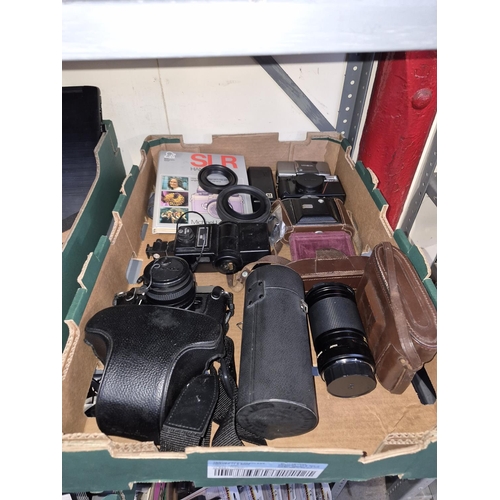 Box containing assorted cameras and lenses including Nikon