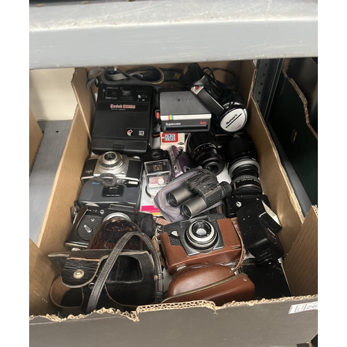 Box containing assorted cameras and lenses including Kodak and Polaroid