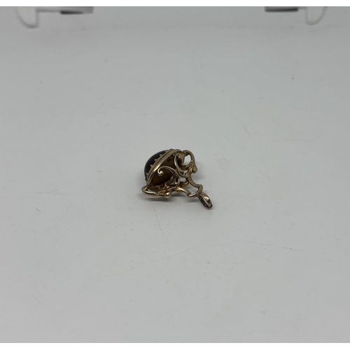33 - 9ct Gold Albert charm featuring a tiger's eye, 5.5g - Only 10% buyer's premium