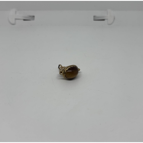 33 - 9ct Gold Albert charm featuring a tiger's eye, 5.5g - Only 10% buyer's premium
