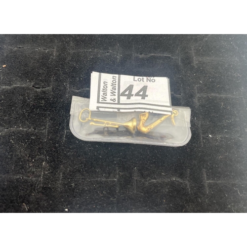 44 - 9ct Gold saxophone and trumpet pendants, 1.4g - Only 10% buyer's premium