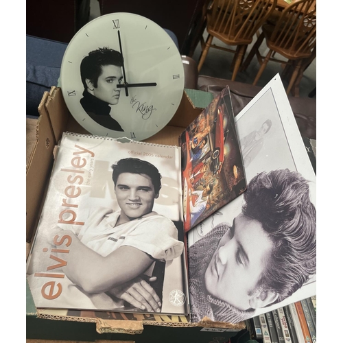 747 - Box containing a quantity of Elvis calendars, wall clock and metal signs