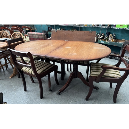 774 - Extending oval dining table with claw feet and 6 chairs