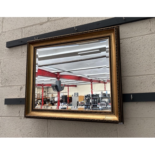 854 - Ornately framed bevel edge mirror (51x61cm)