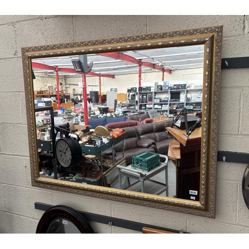 855 - Large ornately framed bevel edge mirror (115x90cm)