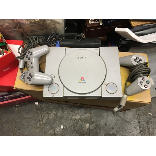 396 - PLAYSTATION WITH TWO CONTROLLERS MAINS POWERS ON AND WORKING