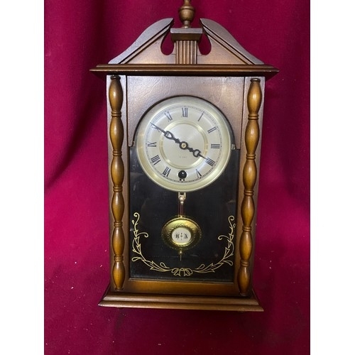 59 - VERY NICE Free standing or wall hanging 15 day clock measuring 20 x 40 cms tall with key