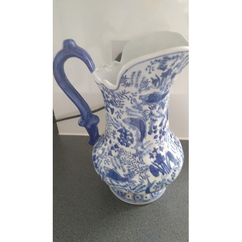 354 - LOVELY BLUE AND WHITE JUG EASTERN FISH DESIGN MARKED TO BASE