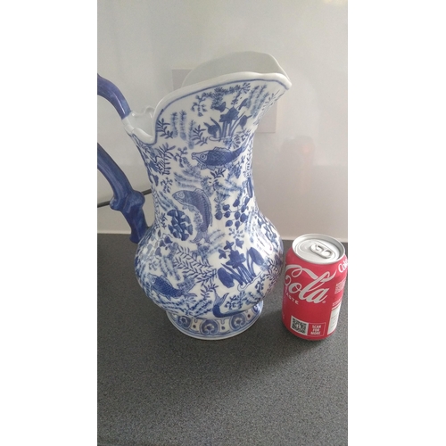 354 - LOVELY BLUE AND WHITE JUG EASTERN FISH DESIGN MARKED TO BASE