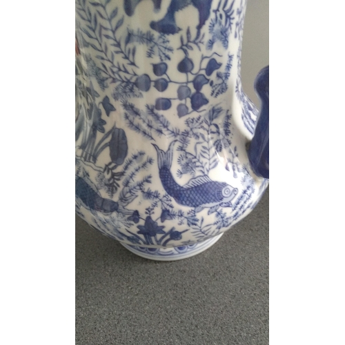 354 - LOVELY BLUE AND WHITE JUG EASTERN FISH DESIGN MARKED TO BASE