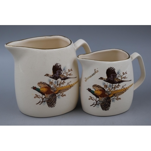 14 - TWO West Highland Pottery Graduated Whisky Water Jugs