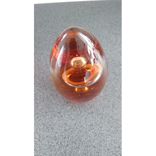 521 - AMBER COLOURED PAPERWEIGHT SIGNED TO BASE